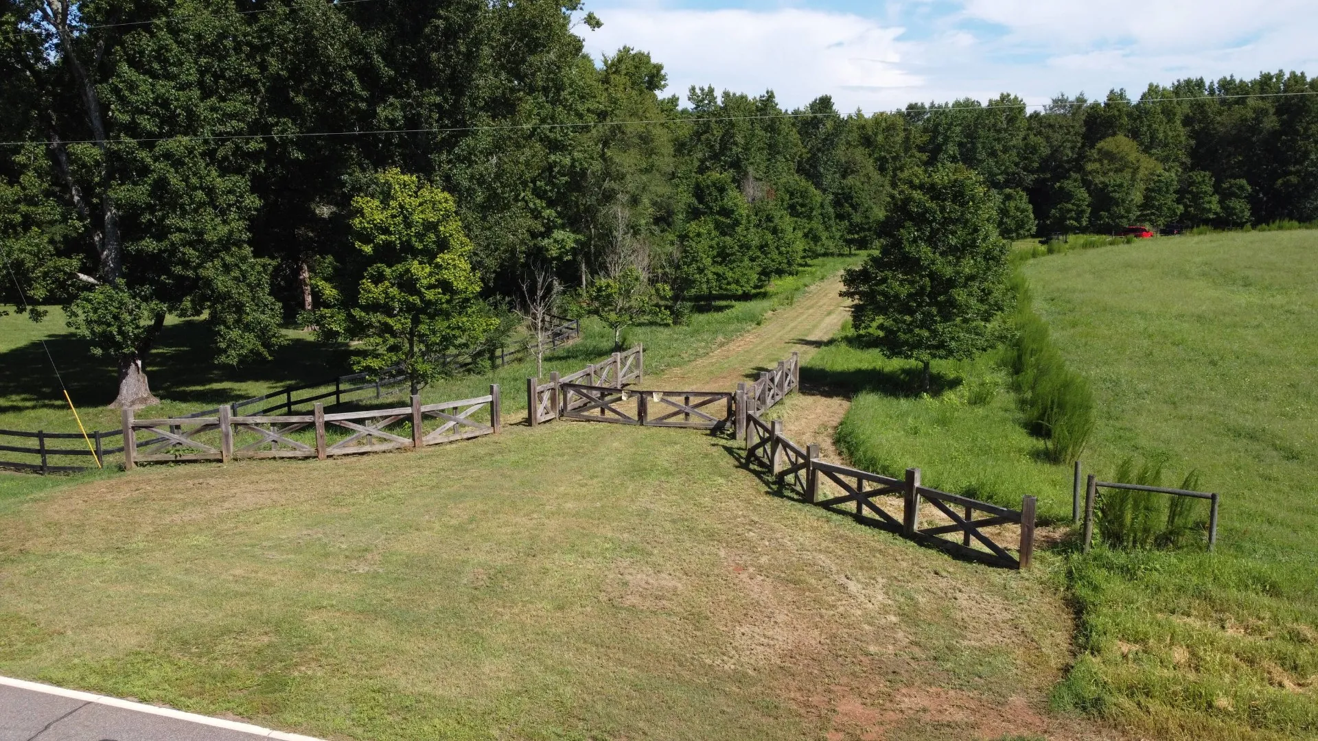 Wooden cross-rail fence and gated entry to pastoral residential development tract in Oconee County, GA