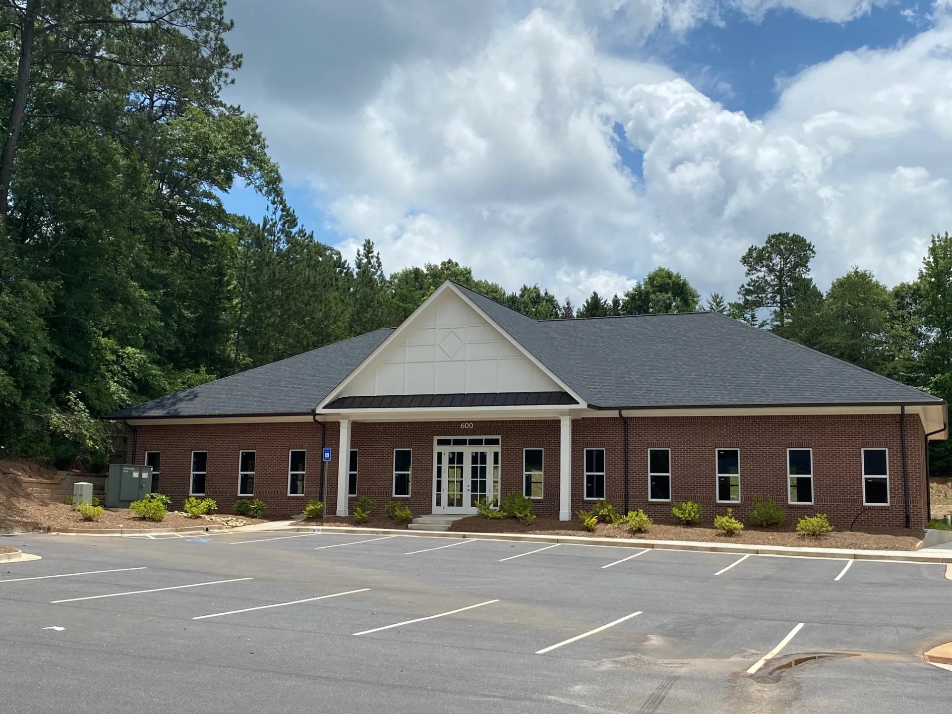 Brick professional office building at 600 with gabled entry and landscaped parking lot